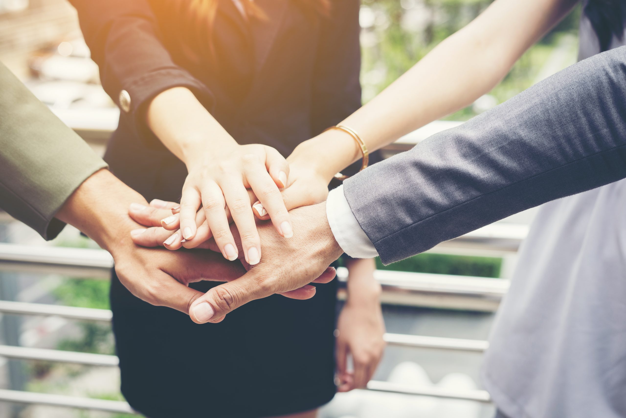 Close up of business people hands together